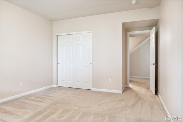 104 Eagle Cove Pl Unit 39B, Saint Charles, MO 63303 - unfurnished bedroom featuring light carpet, a closet, and baseboards