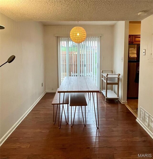 1504 Swallow Dr, Saint Louis, MO 63144 - dining area with dark wood-type flooring, a textured ceiling, and baseboards