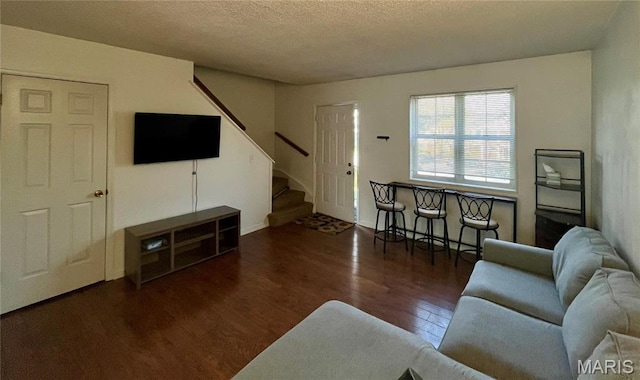 1504 Swallow Dr, Saint Louis, MO 63144 - living area featuring wood finished floors, stairs, and a textured ceiling