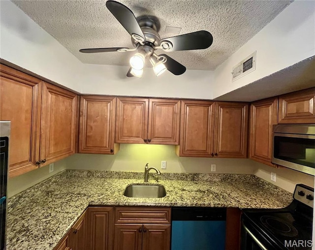 1504 Swallow Dr, Saint Louis, MO 63144 - kitchen with stainless steel appliances, a sink, a textured ceiling, ceiling fan, and light stone countertops