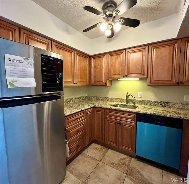 1504 Swallow Dr, Saint Louis, MO 63144 - kitchen with freestanding refrigerator, dishwasher, a sink, a textured ceiling, and brown cabinets