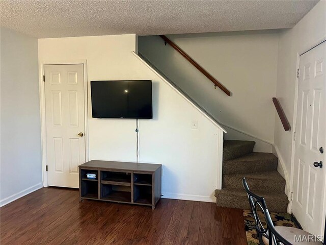 1504 Swallow Dr, Saint Louis, MO 63144 - staircase featuring wood finished floors, a textured ceiling, and baseboards
