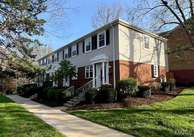 1504 Swallow Dr, Saint Louis, MO 63144 - view of front facade featuring brick siding and a front yard