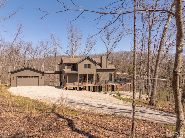370 Alpine Bend Dr, Wright City, MO 63390 - view of front of house featuring a chimney, dirt driveway, a deck, and an outbuilding