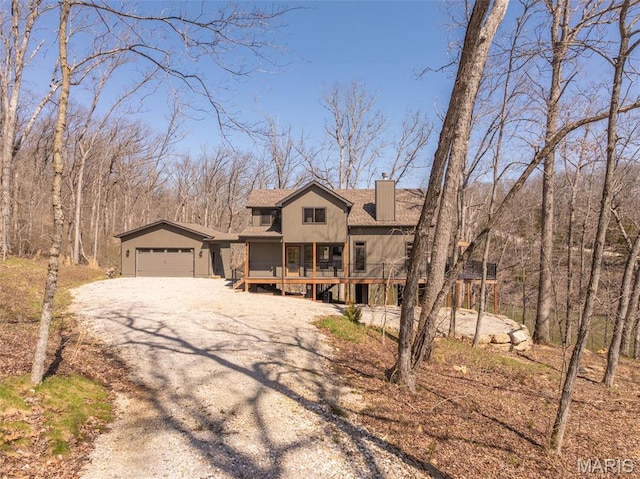 370 Alpine Bend Dr, Wright City, MO 63390 - view of front facade featuring a chimney, dirt driveway, a garage, and a wooden deck