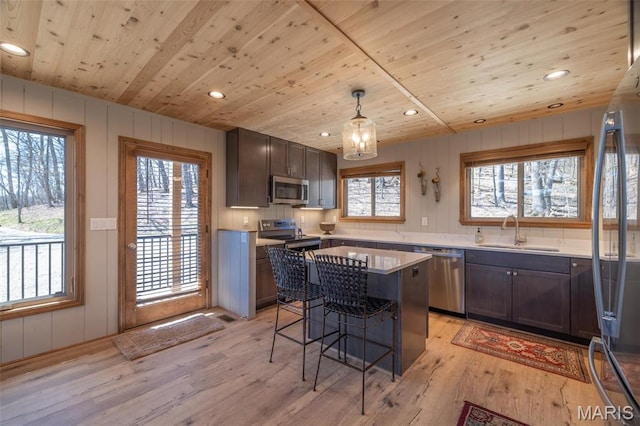 370 Alpine Bend Dr, Wright City, MO 63390 - kitchen featuring a sink, appliances with stainless steel finishes, wooden ceiling, a breakfast bar, and light wood-style floors