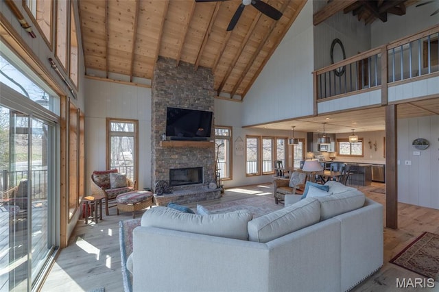 370 Alpine Bend Dr, Wright City, MO 63390 - living area featuring high vaulted ceiling, a fireplace, healthy amount of natural light, light wood-style flooring, and beamed ceiling