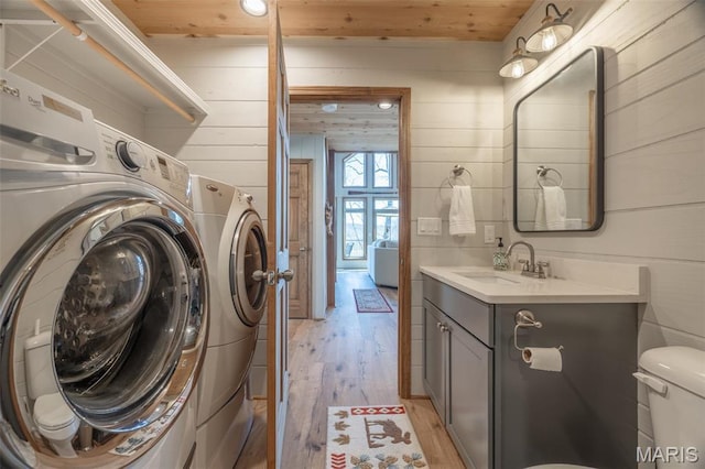 370 Alpine Bend Dr, Wright City, MO 63390 - laundry area featuring washing machine and dryer, light wood-style floors, wooden walls, and wood ceiling