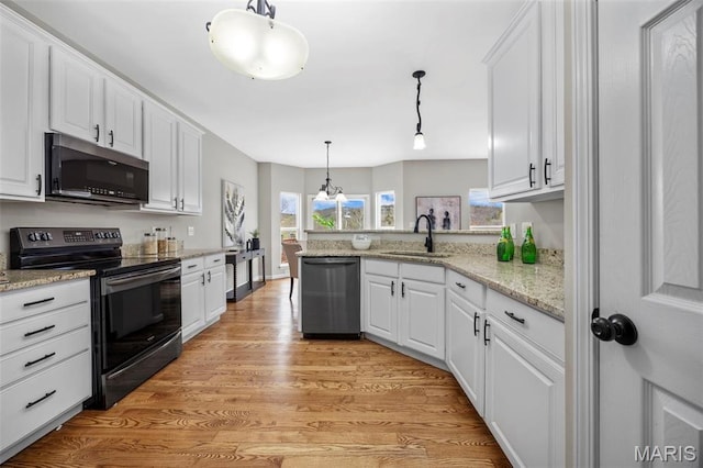 407 Forby Estates Dr, Eureka, MO 63025 - kitchen with appliances with stainless steel finishes, a sink, white cabinetry, a peninsula, and light wood-style floors