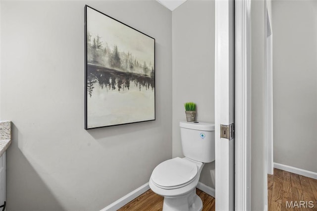 407 Forby Estates Dr, Eureka, MO 63025 - bathroom featuring wood finished floors, toilet, and baseboards
