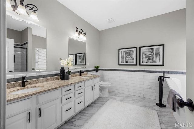 407 Forby Estates Dr, Eureka, MO 63025 - bathroom featuring marble finish floors, tile walls, wainscoting, toilet, and double vanity
