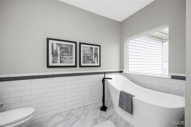 407 Forby Estates Dr, Eureka, MO 63025 - full bath featuring tile walls, marble finish flooring, wainscoting, a soaking tub, and plenty of natural light
