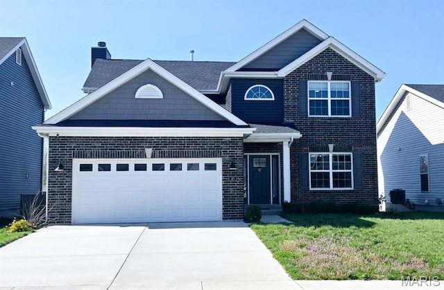 145 Pampano Ln, Saint Charles, MO 63301 - view of front facade with a chimney, concrete driveway, a garage, brick siding, and a front lawn
