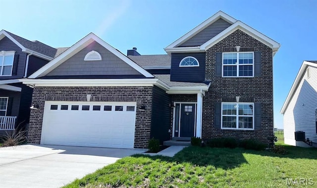 145 Pampano Ln, Saint Charles, MO 63301 - view of front facade featuring brick siding, a front yard, driveway, and a garage