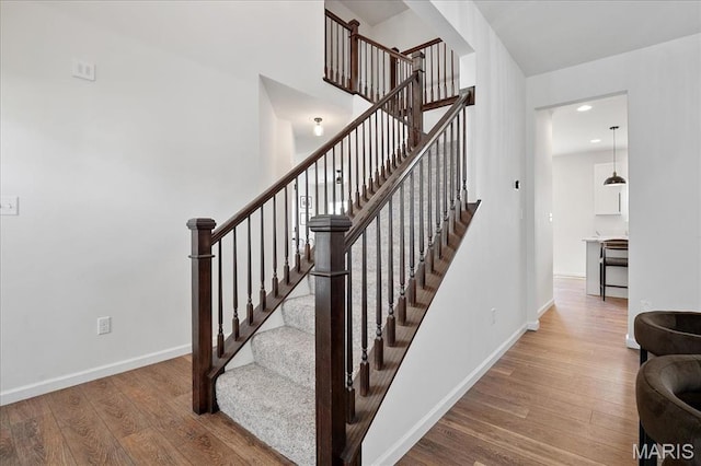 145 Pampano Ln, Saint Charles, MO 63301 - stairway featuring wood finished floors, baseboards, and recessed lighting