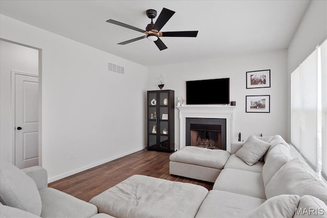 145 Pampano Ln, Saint Charles, MO 63301 - living room featuring a ceiling fan, dark wood-style flooring, a fireplace, and baseboards