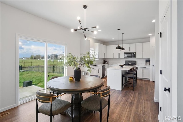 145 Pampano Ln, Saint Charles, MO 63301 - dining space with a chandelier, dark wood-style flooring, recessed lighting, and baseboards