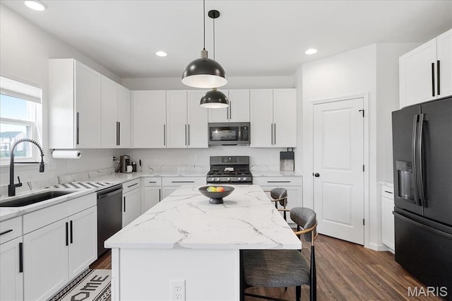 145 Pampano Ln, Saint Charles, MO 63301 - kitchen featuring black fridge with ice dispenser, stainless steel microwave, gas range oven, a sink, and dishwashing machine