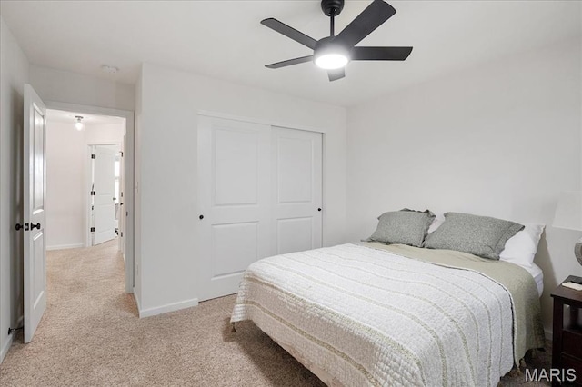 145 Pampano Ln, Saint Charles, MO 63301 - bedroom featuring light carpet, baseboards, a closet, and ceiling fan