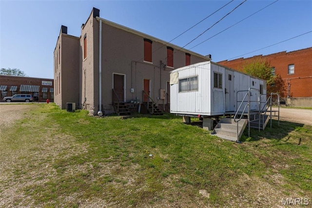 32 W School St, Bonne Terre, MO 63628 - rear view of house with entry steps, central AC unit, and a yard