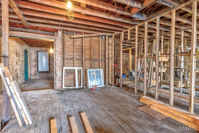 32 W School St, Bonne Terre, MO 63628 - misc room featuring wood-type flooring and brick wall