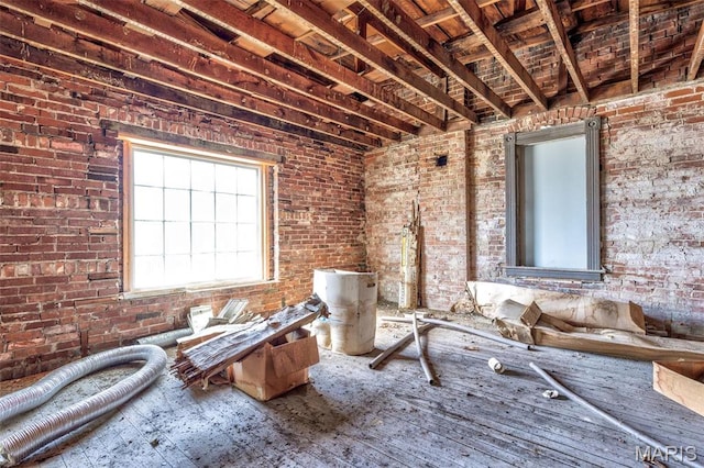 32 W School St, Bonne Terre, MO 63628 - miscellaneous room with brick wall and hardwood / wood-style floors