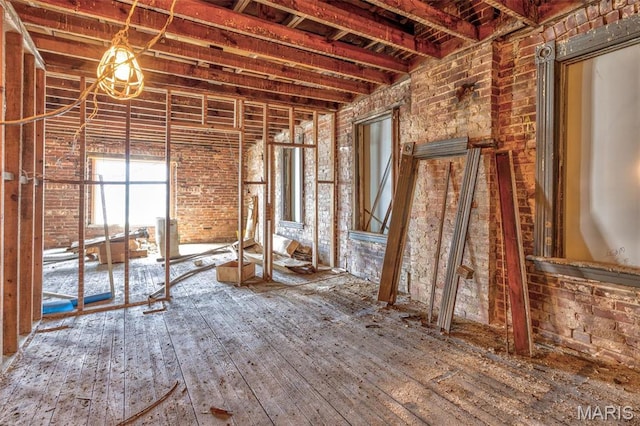 32 W School St, Bonne Terre, MO 63628 - miscellaneous room with brick wall and hardwood / wood-style floors