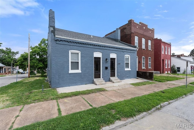6800 Minnesota Ave, Saint Louis, MO 63111 - view of property featuring brick siding, roof with shingles, a chimney, and a front yard