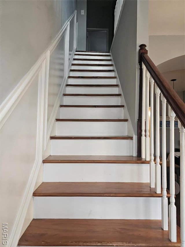 stairs featuring wood finished floors