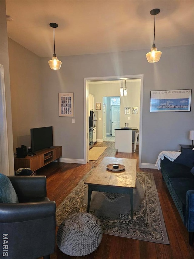 living room featuring wood finished floors and baseboards