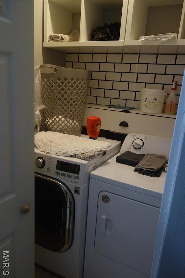 laundry room featuring washing machine and clothes dryer