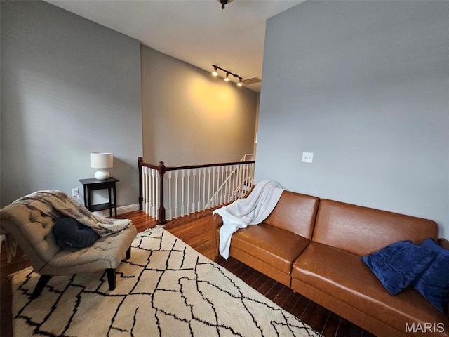 living room featuring wood finished floors and rail lighting