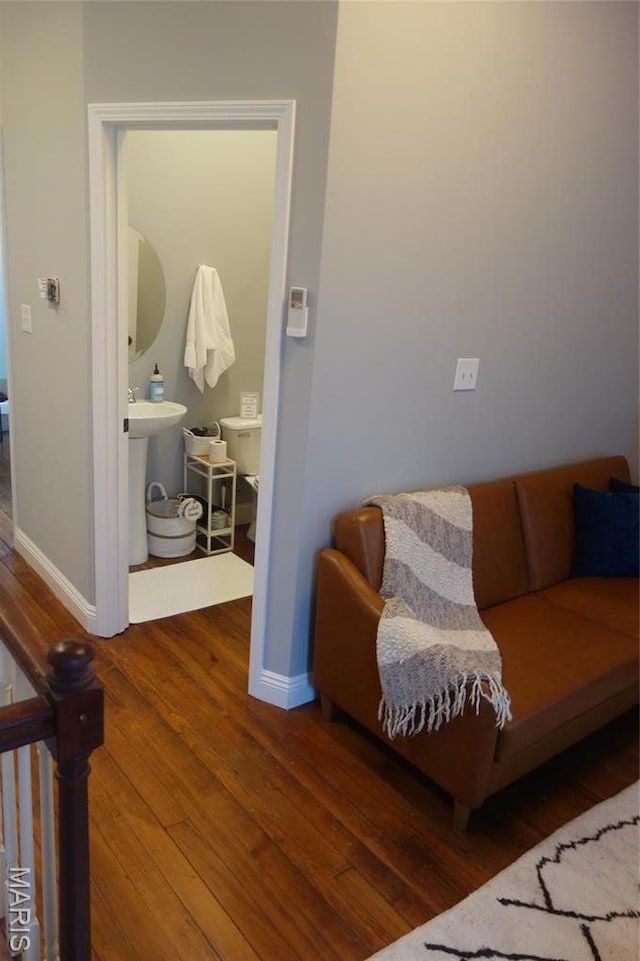 living area featuring wood finished floors and baseboards