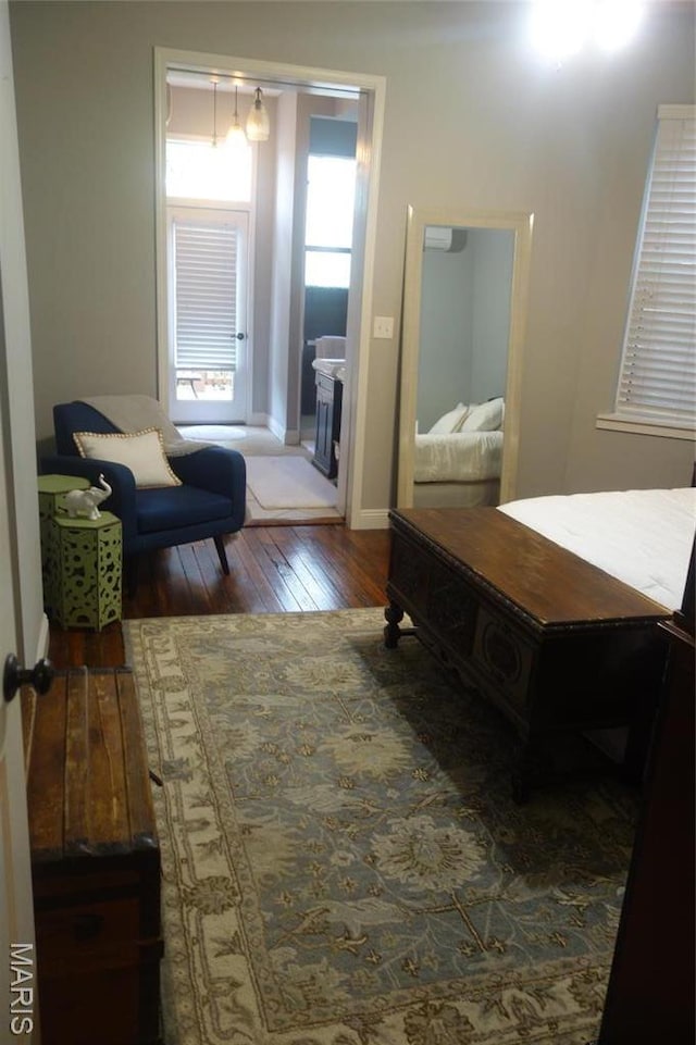 bedroom featuring hardwood / wood-style flooring and baseboards