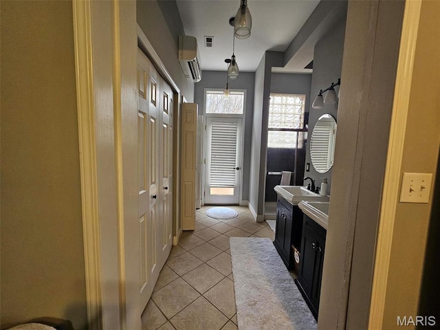 bathroom featuring a wall mounted air conditioner, tile patterned flooring, vanity, and baseboards