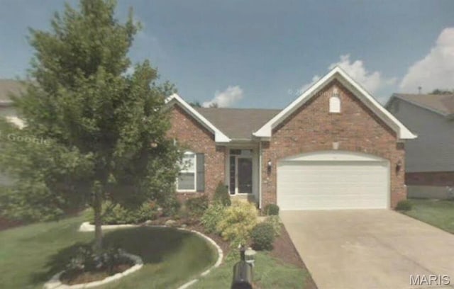 view of front facade featuring brick siding, an attached garage, and concrete driveway