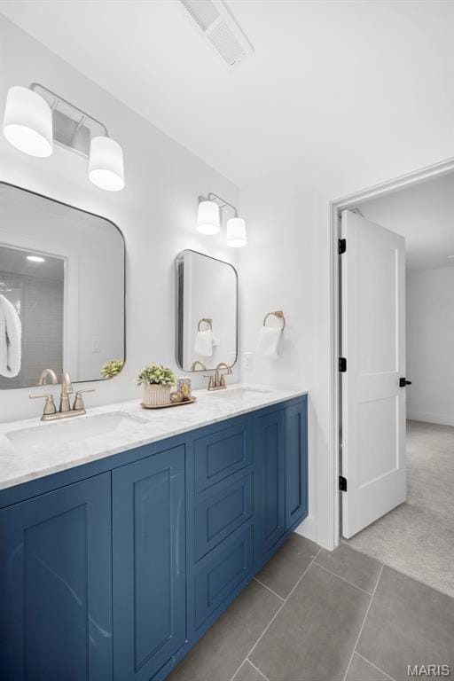 full bath with double vanity and tile patterned flooring