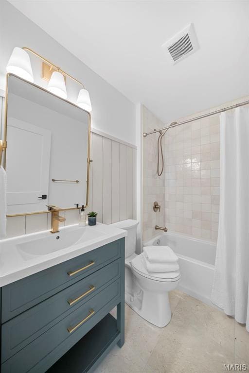 full bathroom featuring toilet, shower / bath combination with curtain, and vanity