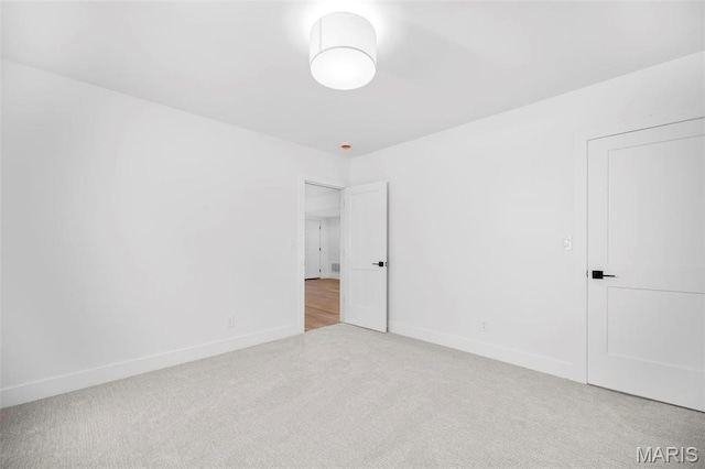 unfurnished bedroom featuring carpet and baseboards