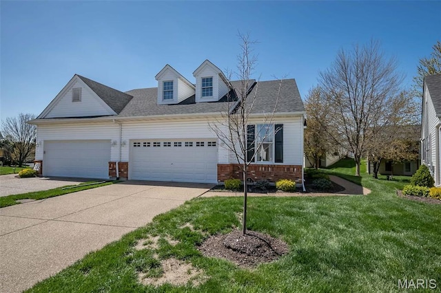view of front of property featuring brick siding, an attached garage, driveway, and a front yard