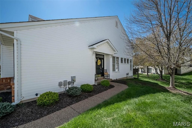 view of side of property with a lawn
