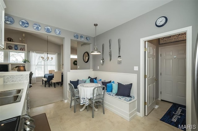 dining room with a chandelier and baseboards