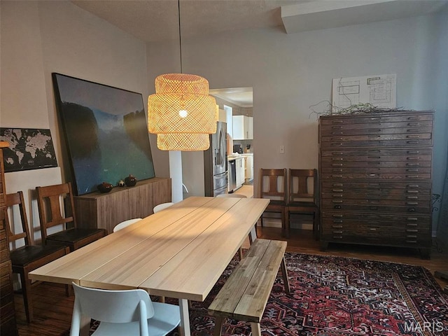 dining space with wood finished floors