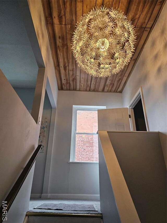 stairway with wood ceiling