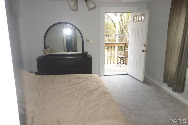 carpeted bedroom featuring access to outside and baseboards