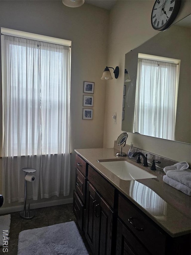 full bath featuring healthy amount of natural light, vanity, tile patterned flooring, and curtained shower