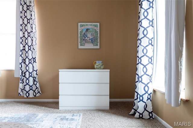 bedroom with multiple windows and baseboards