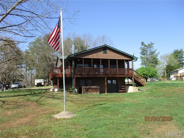 1653 Lakeshore Dr, Cuba, MO 65453 - back of property with a hot tub, a wooden deck, a lawn, and stairs