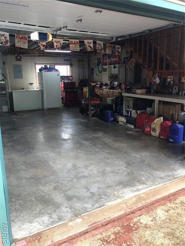 1653 Lakeshore Dr, Cuba, MO 65453 - garage featuring a garage door opener, a workshop area, and electric panel