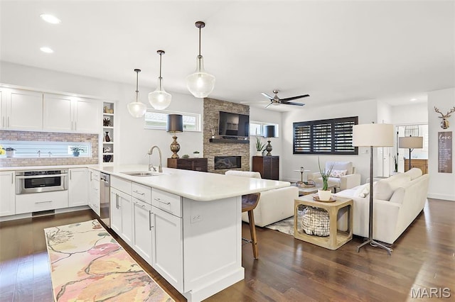 1420 Randle St, Edwardsville, IL 62025 - kitchen with open floor plan, a sink, a peninsula, appliances with stainless steel finishes, and a ceiling fan